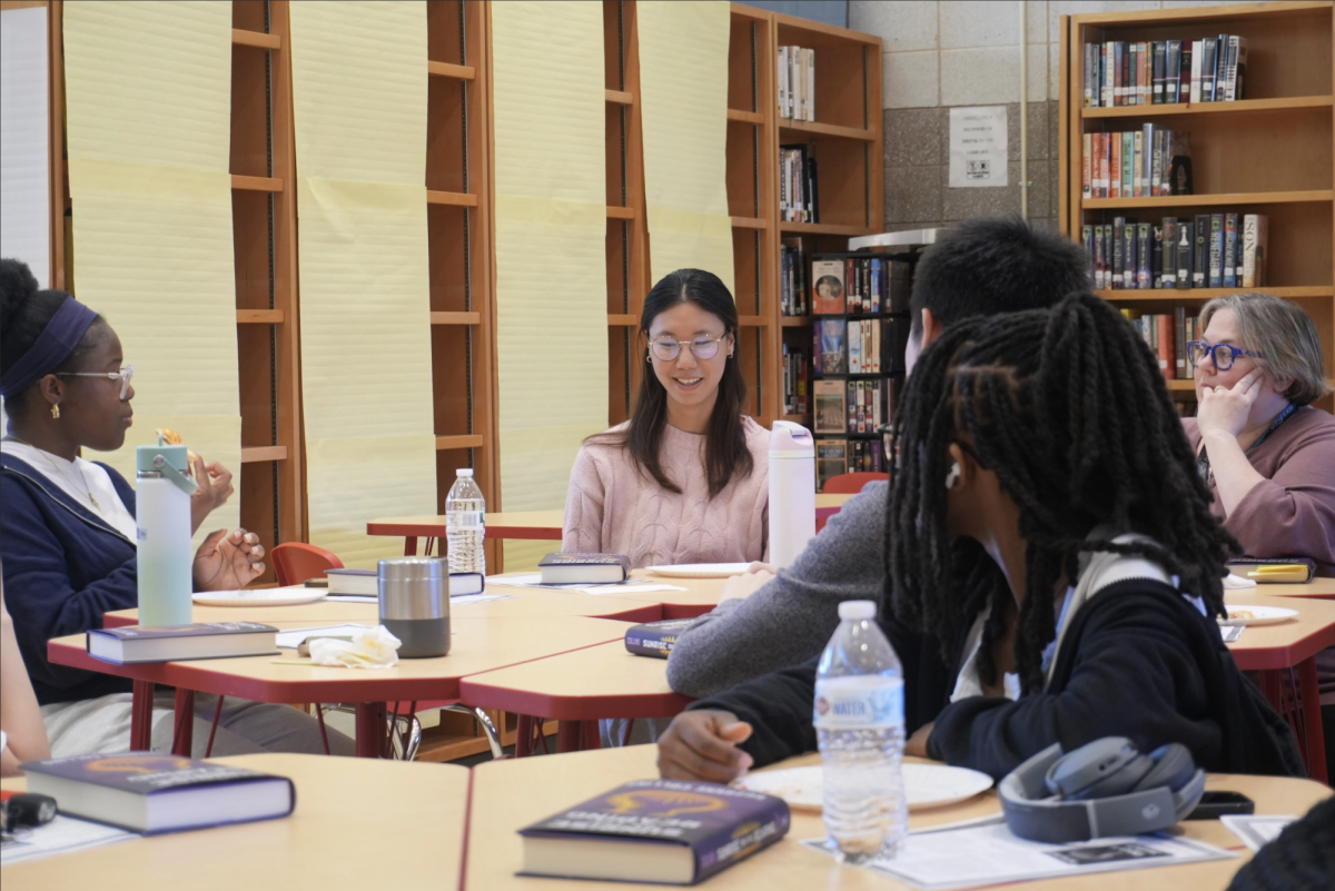 Participants discussing the new Hunger Games book: Sunrise on the Reaping in the library. 